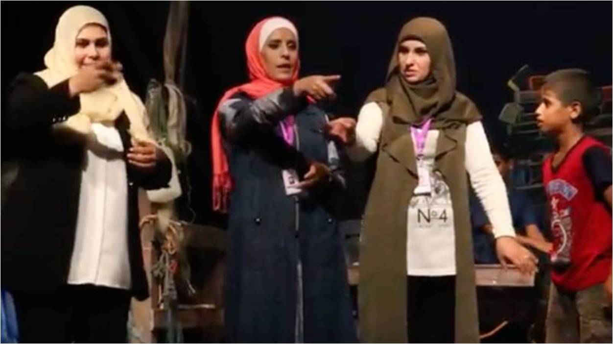 Three Gazan women behind an all-female theater